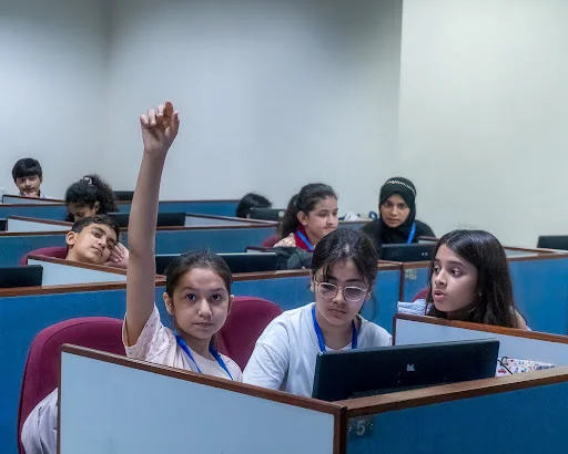 Teacher guiding students in a makerspace activity